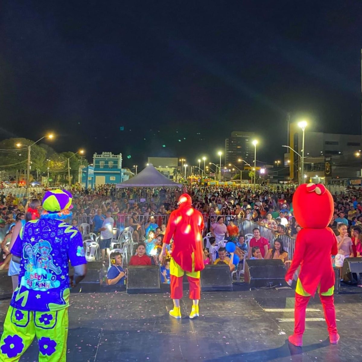 Tote Barreto e personagens no palco com a plateia de famílias